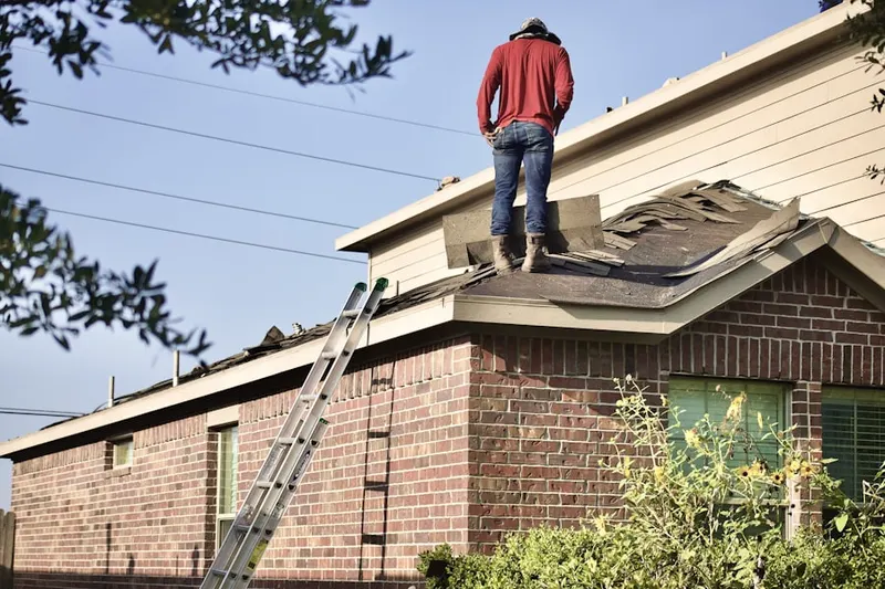 Professional roofer working on a residential roof in West Mecox Village